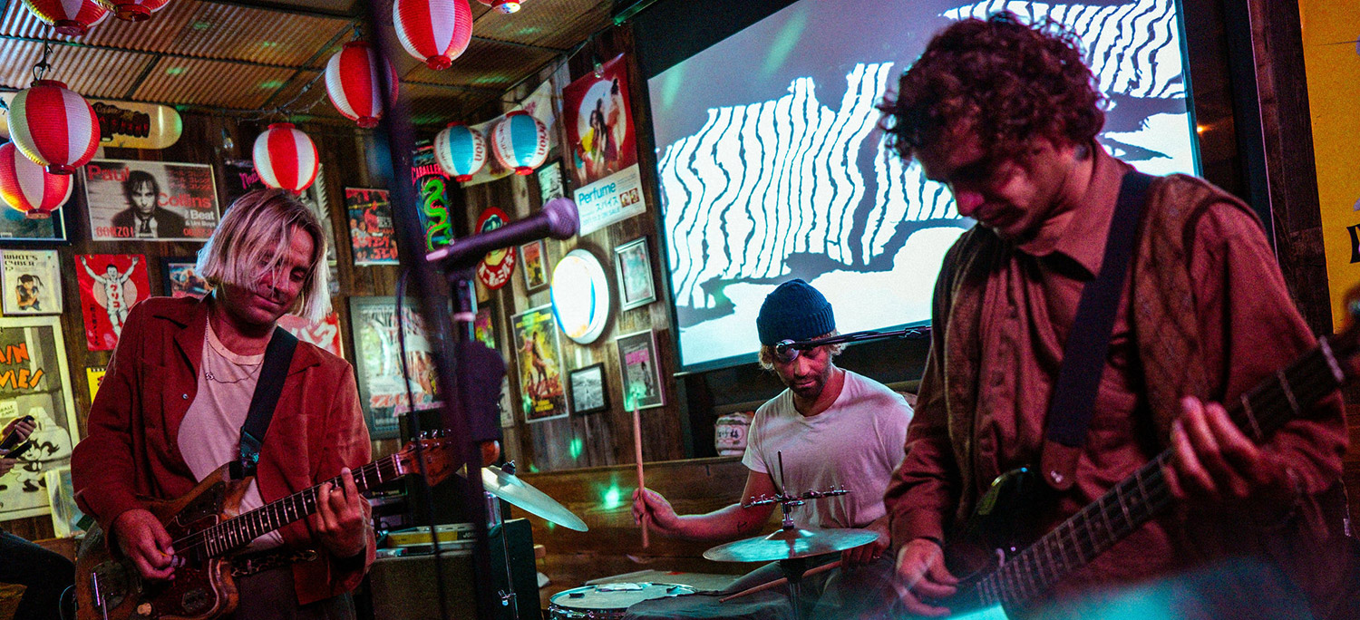 Live band performing in a colorful, intimate music venue